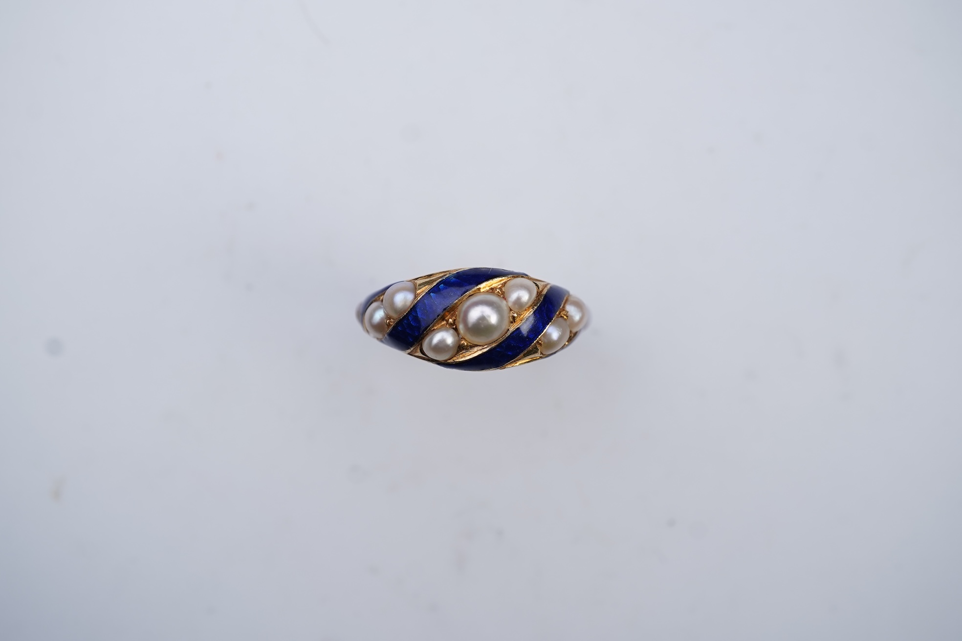 A Victorian half pearl and blue enamel ring, mid 19th century